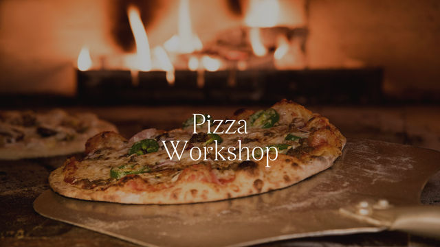 a pizza on a peel with a fire in the background